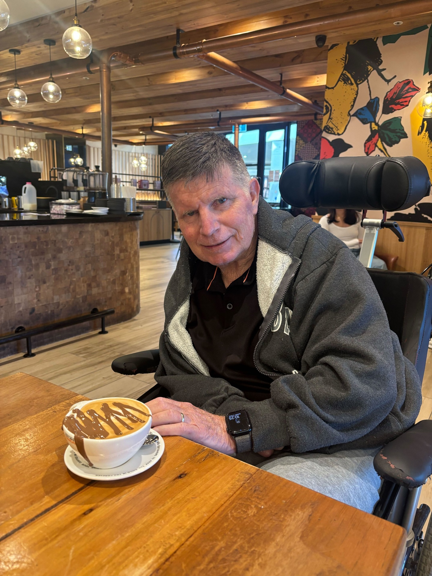 A participant enjoying a coffee out in the community